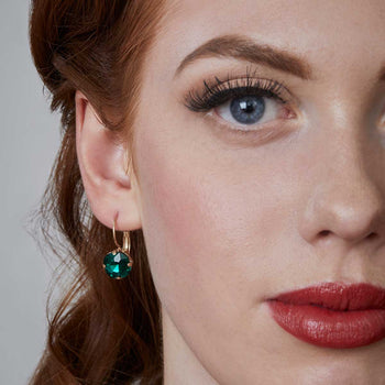 cushion cut earring in emerald inspired by the 1950s vintage inspired jewellery by lovett and co pictured on a model