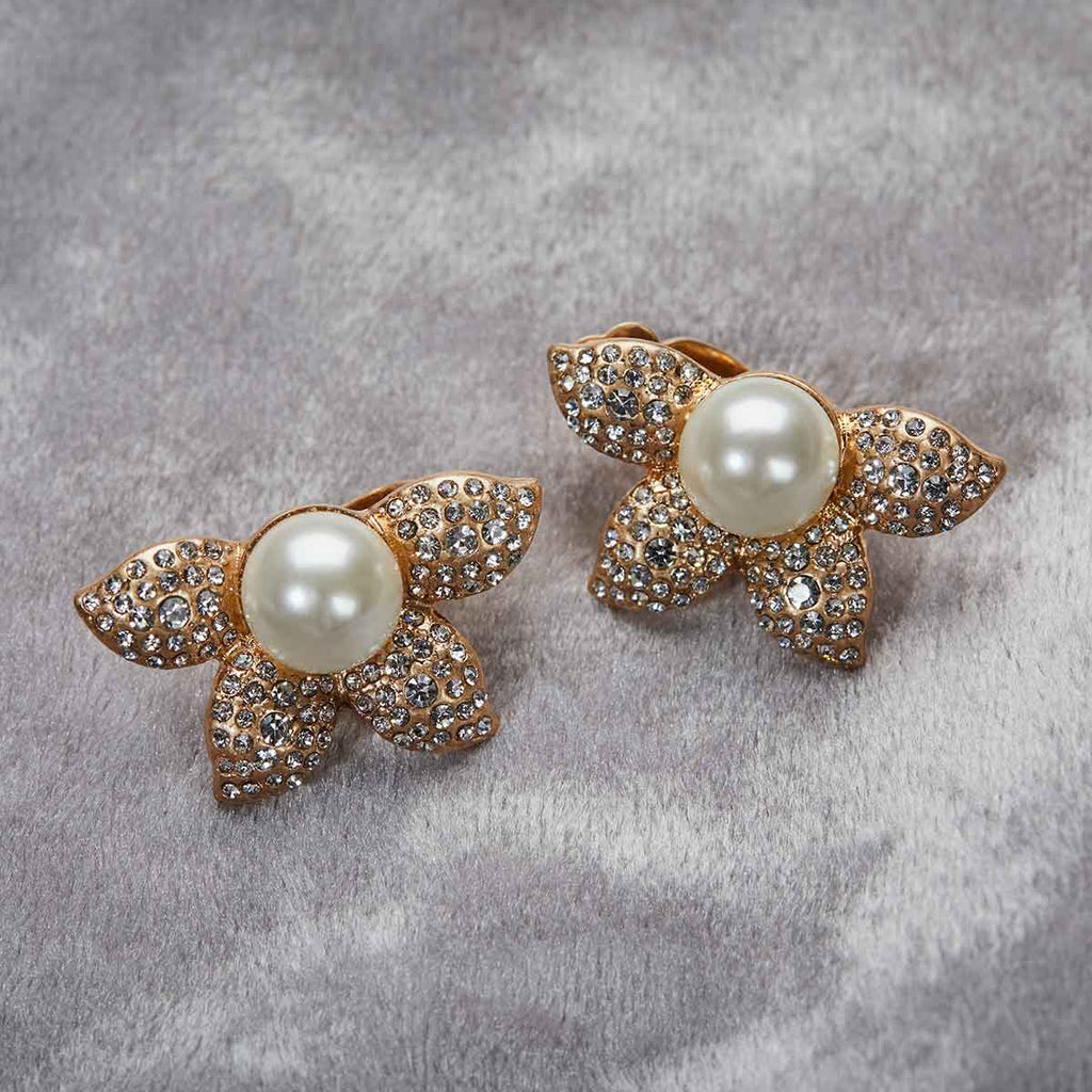 Pearl flower clip on earring, large pearl in the centre with diamantes encrusted on the flower pictured on a grey background 1950's vintage inspired earrings by lovett and co
